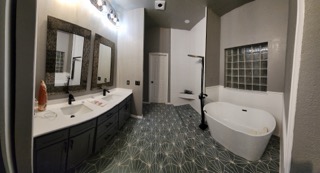 Double vanity wide view with geometric tile floor