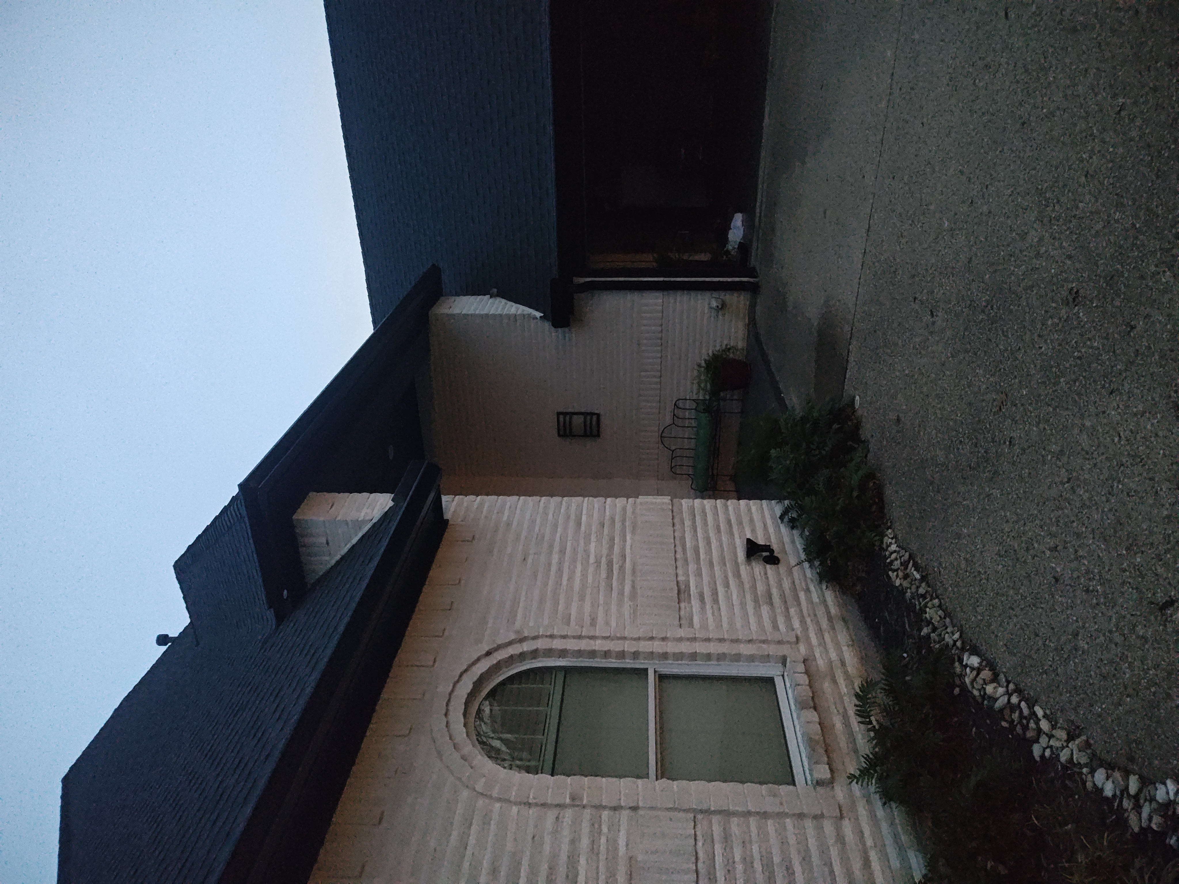 Completed patio night view showing windows and painted trim