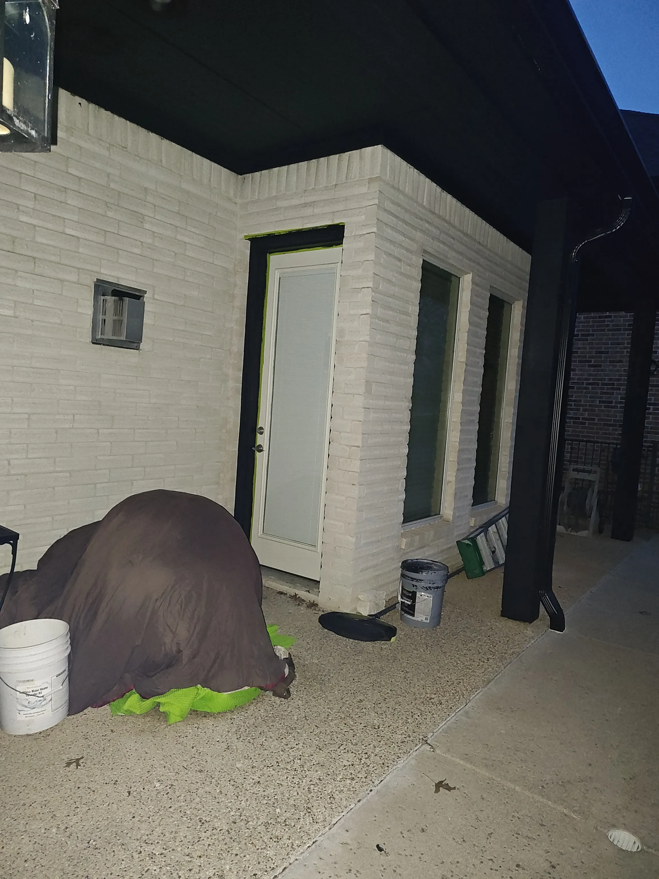 Covered patio exterior at night after black paint