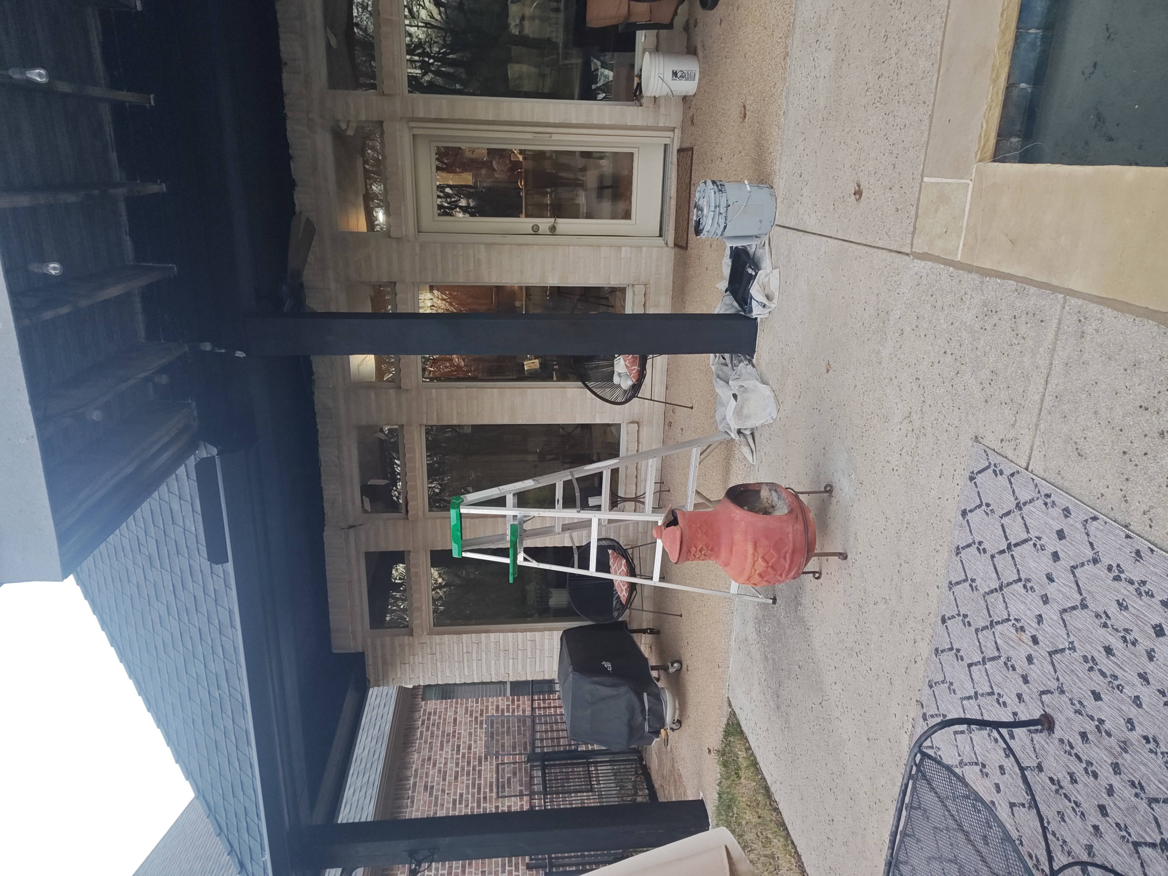 Painted black patio column with decorative bracket poolside