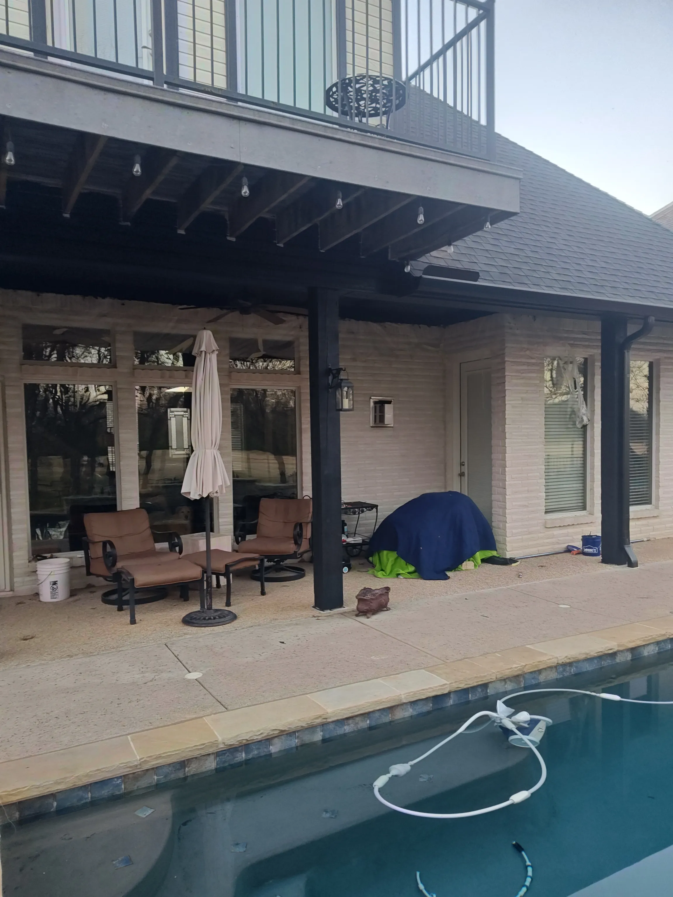 Completed painted patio with lantern light at dusk