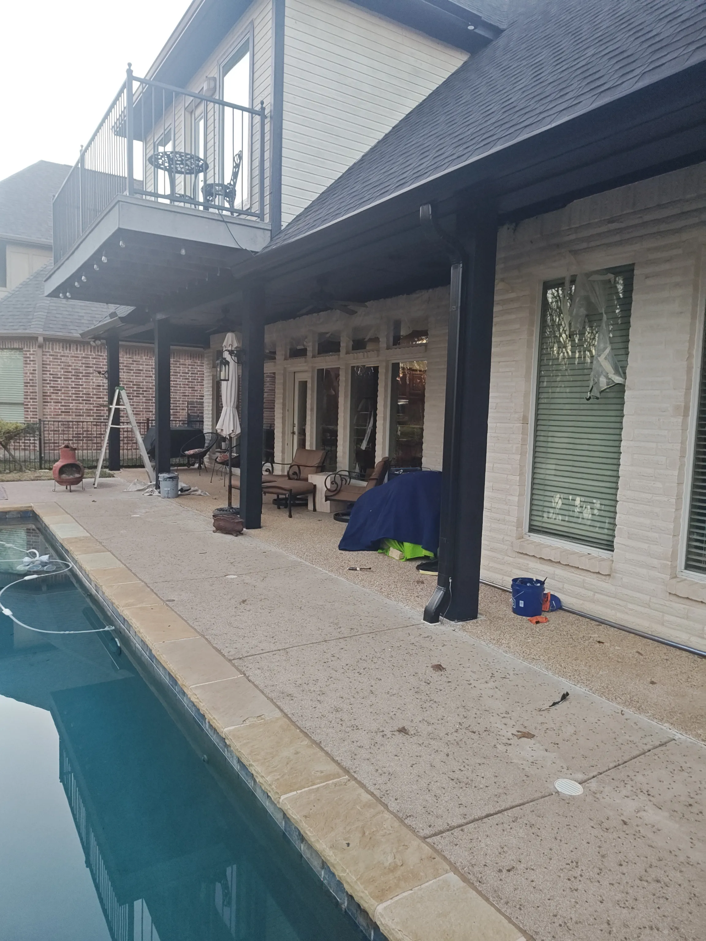 Patio wall with window trim masked for paint